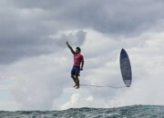 The best image of the games: a surfer flying over the water