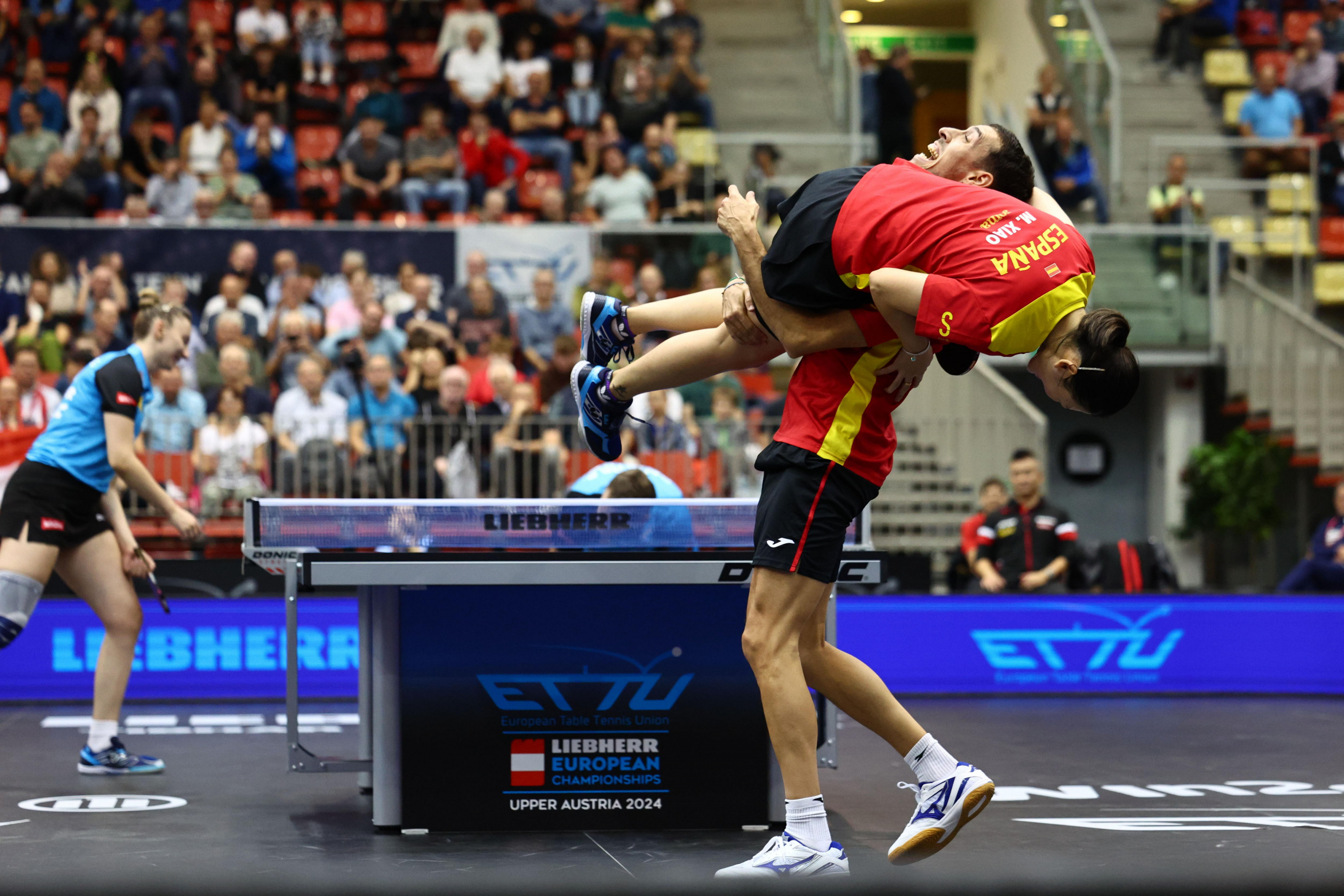 Ochelvaro Robles takes Maria Xiao in his arms after winning the semifinal match of the European Championship in Linz.