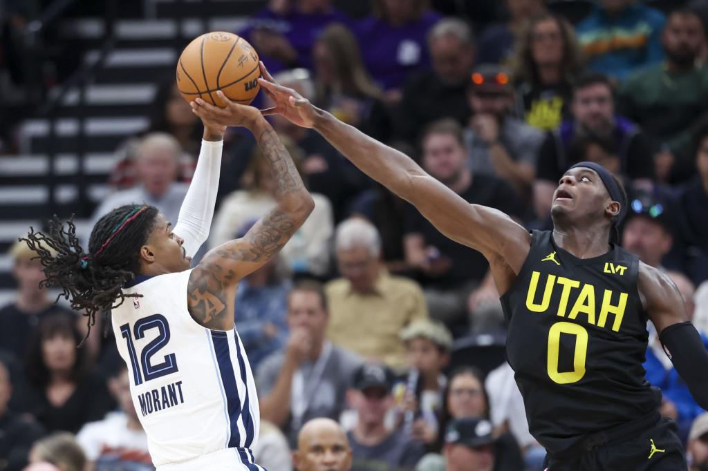 Utah Jazz forward Taylor Hendricks (0) shoots Memphis Grizzlies guard Ja Morant (12) during the second half of an NBA basketball game, Wednesday, Oct. 23, 2024, in Salt Lake City. (AP Photo / Rob Gray)