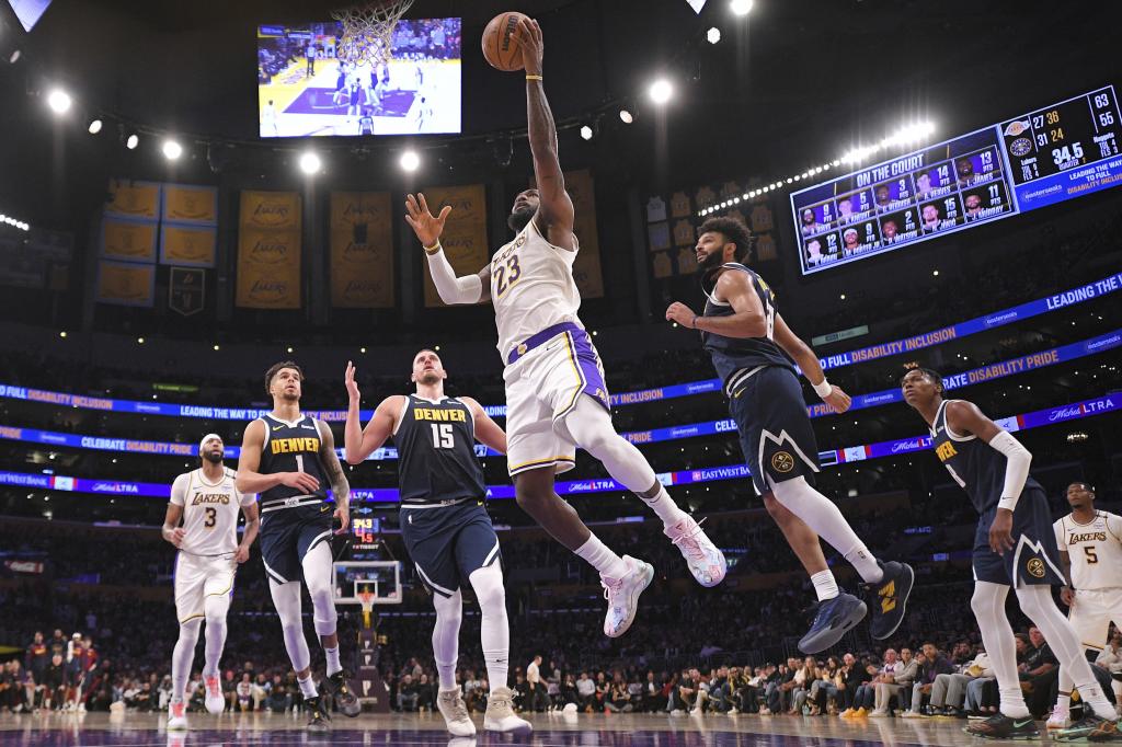 Los Angeles Lakers forward LeBron James (23) shoots Denver Nuggets forward Michael Porter Jr. (1), center Nikola Jokic (15), guard Jamal Murray (27) and forward Michael Porter Jr. (1) defend during the first half of an NBA basketball game, Saturday, Nov. 23, 2024, in Los Angeles. (AP Photo / Mark J. Terrell)