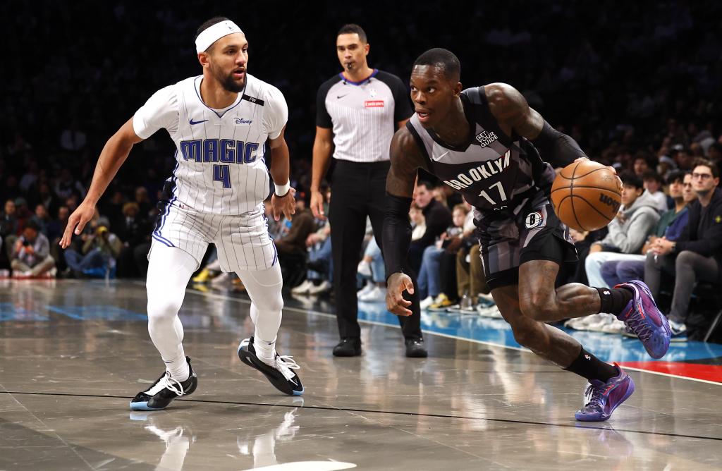 Brooklyn Nets guard Dennis Schroeder (17) drives to the basket against Orlando Magic guard Jalen Suggs (4) during the first half of an NBA basketball game, Sunday, Dec. 1, 2024, in New York. (AP Photo/Noah K. Murray)